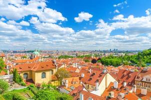 Top aerial panoramic view of Prague historical city centre with red tiled roof buildings