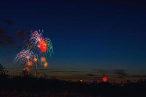 Brightly colorful firework in dark blue evening sky photo