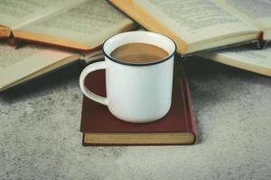 Books and cup of coffee. Selective focus photo