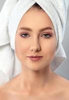 Portrait of young woman with towel on her hair photo