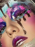 Closeup view of woman face with creative makeup photo