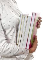 Woman holding stack of books closeup photo