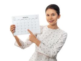 Young woman holding monthly calendar photo