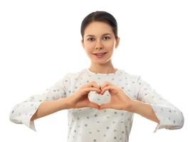 Woman making heart shape gesture with her fingers photo