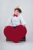 thoughtful child with a red heart photo