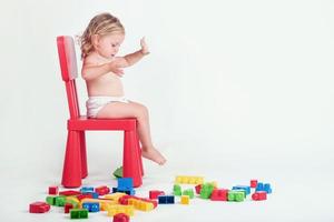 baby girl playing with building blocks photo