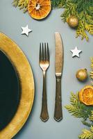 Christmas concept background. Vintage old cutlery, plate for Christmas Dinner and christmas ornament. Christmas dinner concept photo