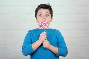 surprised child with lollipop photo