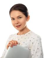 Smiling woman holding closed laptop computer photo