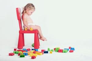 sad baby girl with building blocks photo