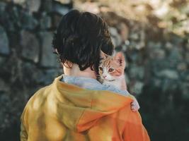 Back view of child with kitten photo