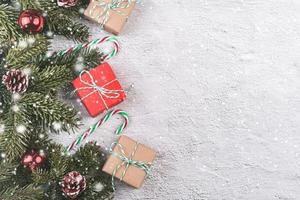 Merry Christmas.Christmas concept background.Christmas tree branches and Christmas gifts with snowflakes photo