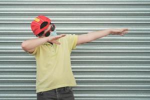 happy kid wearing medical mask for coronavirus with sunglasses and cap photo