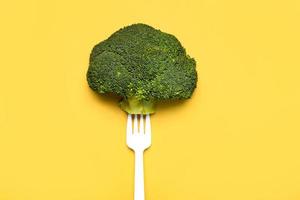 Fresh broccoli on a white plastic fork.Healthy food lifestyle photo
