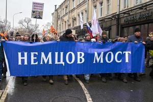 Moscow, Russia - February 24, 2019. Nemtsov memorial march. Demonstrators carrying a big banner Nemtsov Bridge - requirement to the authorities to name his name the bridge on which he was killed