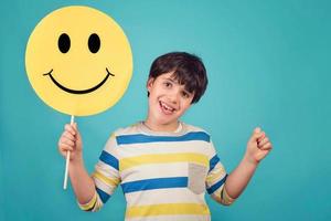 un niño con una cara de emoticon feliz foto