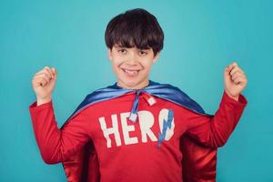 Happy little child playing superhero photo