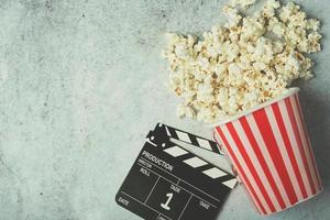 Cinema movie concept, popcorn and clapperboard photo