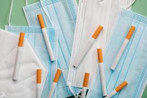 Protective surgical masks with a cigarettes.Coronavirus epidemic concept photo