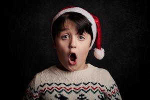 surprised child with Christmas' hat photo