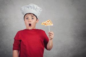 funny child eating a slice of pizza photo