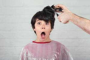 surprised boy at the hairdresser photo
