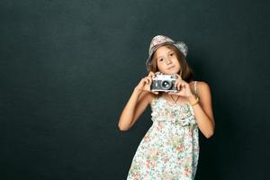 beautiful smiling girl with white teeth holding a instant camera photo