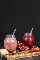 freshly prepared smoothies from banana with pomegranate and banana with blackberry in bottle. Diet, healthy lifestyle photo