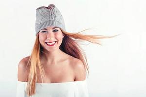 smiling Young woman with winter hat photo