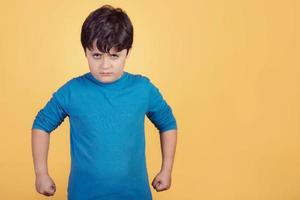 angry boy on yellow background photo