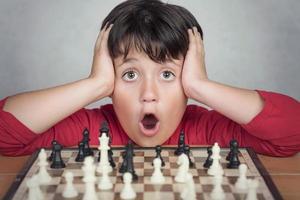 Little boy playing chess photo