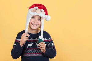 smiling Child Wearing Christmas Santa Claus Hat photo