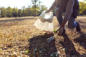 young man picking up trash photo