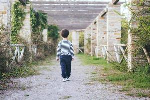 niño caminando por una carretera foto