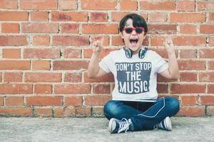 child with headphones connected with digital tablet photo