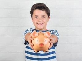 funny child with piggy bank