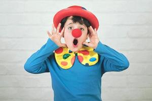 child with clown nose and hat
