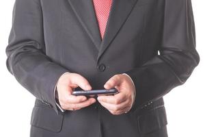Businessman in black suit with mobile phone photo