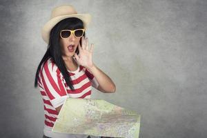 Young woman traveler holding map photo