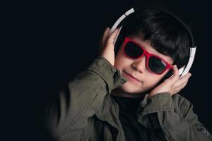 Boy listening to music with headphones photo