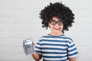 funny child with calculator wearing nerd glasses photo