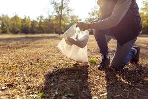 young man picking up trash photo