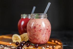 freshly prepared smoothies from banana with pomegranate and banana with blackberry in bottle. Diet, healthy lifestyle photo