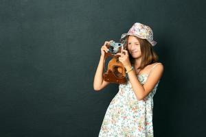 beautiful smiling girl with white teeth holding a instant camera photo