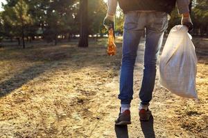 young man picking up trash photo