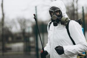 Cleaning and Disinfection at town complex amid the coronavirus epidemic Professional teams for disinfection efforts Infection prevention and control of epidemic Protective suit and mask photo