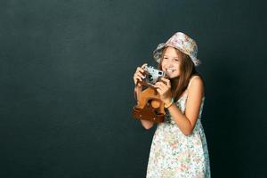 beautiful smiling girl with white teeth holding a instant camera photo