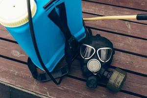 A protective mask and knapsack for disinfection lie on a bench in the urban complex Protection and prevention of the coronavirus epidemic photo