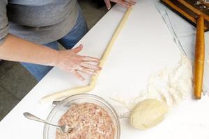 homemade dumplings in the kitchen without decorations. making dumplings with minced pork, beef and chicken photo