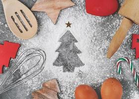 Flour in form of a christmas tree.Baking ingredients and cooking equipment for Christmas cookies photo